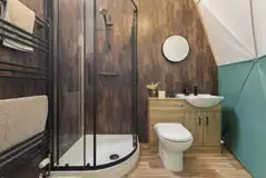 Aries geodome ensuite with toilet, shower, sink and mirror
