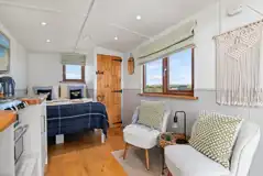 Thrift shepherd's hut interior (pet friendly) with double bed and seating area