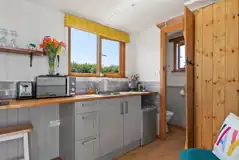 Heather shepherd's hut kitchenette with fridge, kettle, microwave and toaster