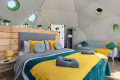 Taurus geodome interior with an indoor kitchen area and sofa