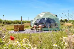 Orion geodome with a private hot tub and bathroom cabin at Stargaze Glamping