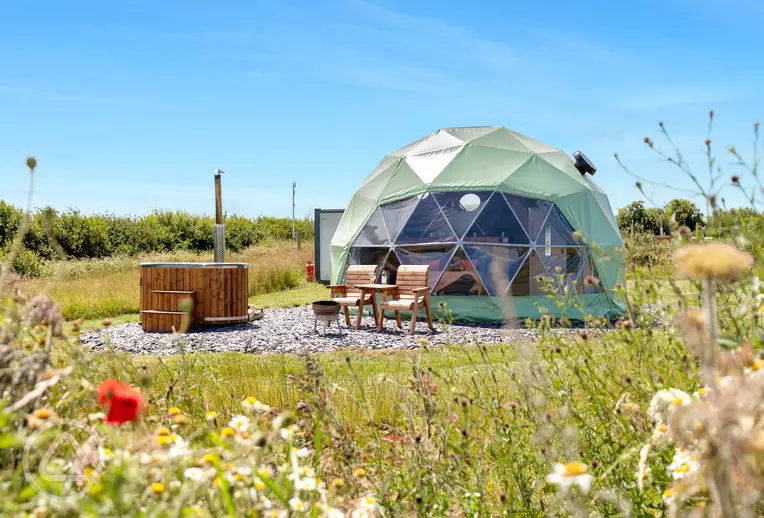 Orion geodome with a private hot tub and bathroom cabin at Stargaze Glamping