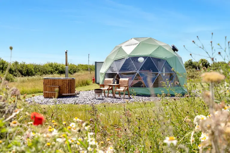 Orion geodome with a private hot tub and bathroom cabin at Stargaze Glamping