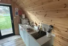 Glamping pod kitchen with a hob, microwave, toaster, sink and fridge/freezer