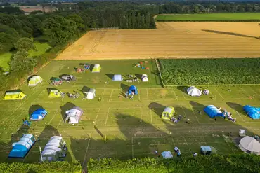 Aerial view of the grass camping pitches with views of the countryside