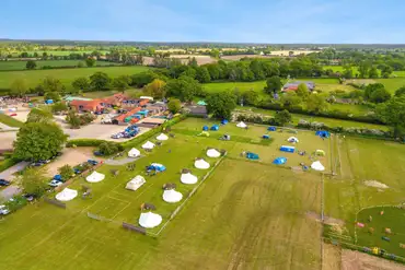 Aerial view of the grass pitches and bell tents at Wroxham Barns 