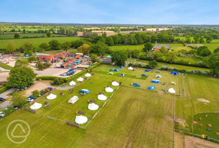 Aerial view of the grass pitches and bell tents at Wroxham Barns 