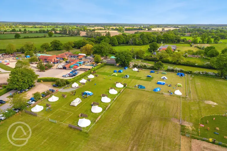 Aerial view of the grass pitches and bell tents at Wroxham Barns 