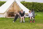 Fully furnished 6m bell tents with a double bed and two singles