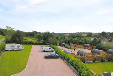 Aerial of the electric grass pitches and glamping pods