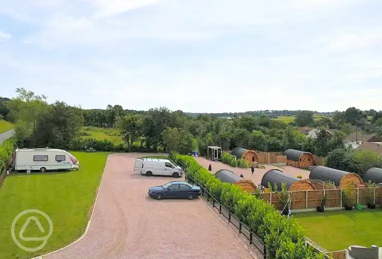 Aerial of the electric grass pitches and glamping pods