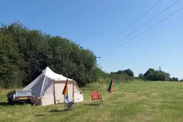 Tent pitched in a secluded camp corner