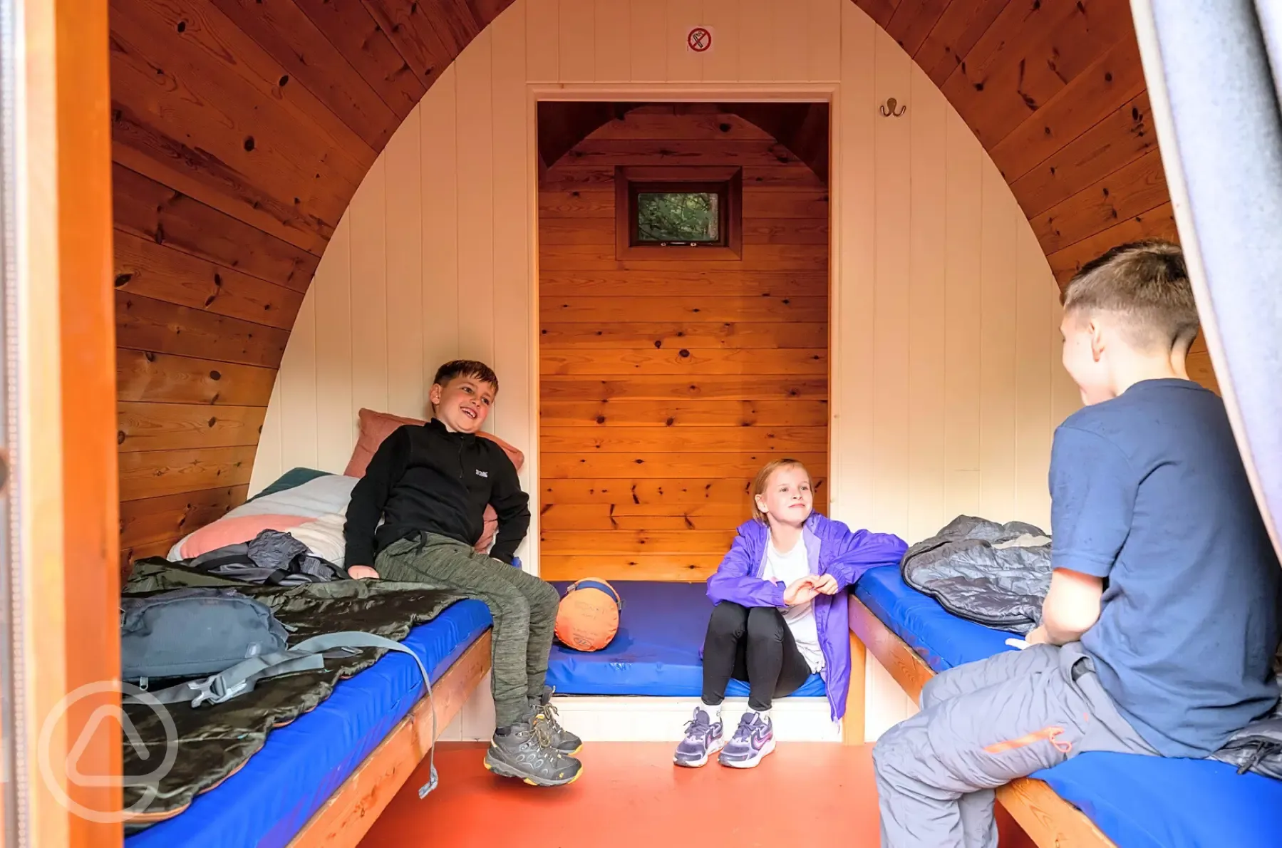 Camping pod interior with a double mattress and two single beds Camping pod interior with a double mattress and two single beds