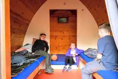 Camping pod interior with a double mattress and two single beds Camping pod interior with a double mattress and two single beds
