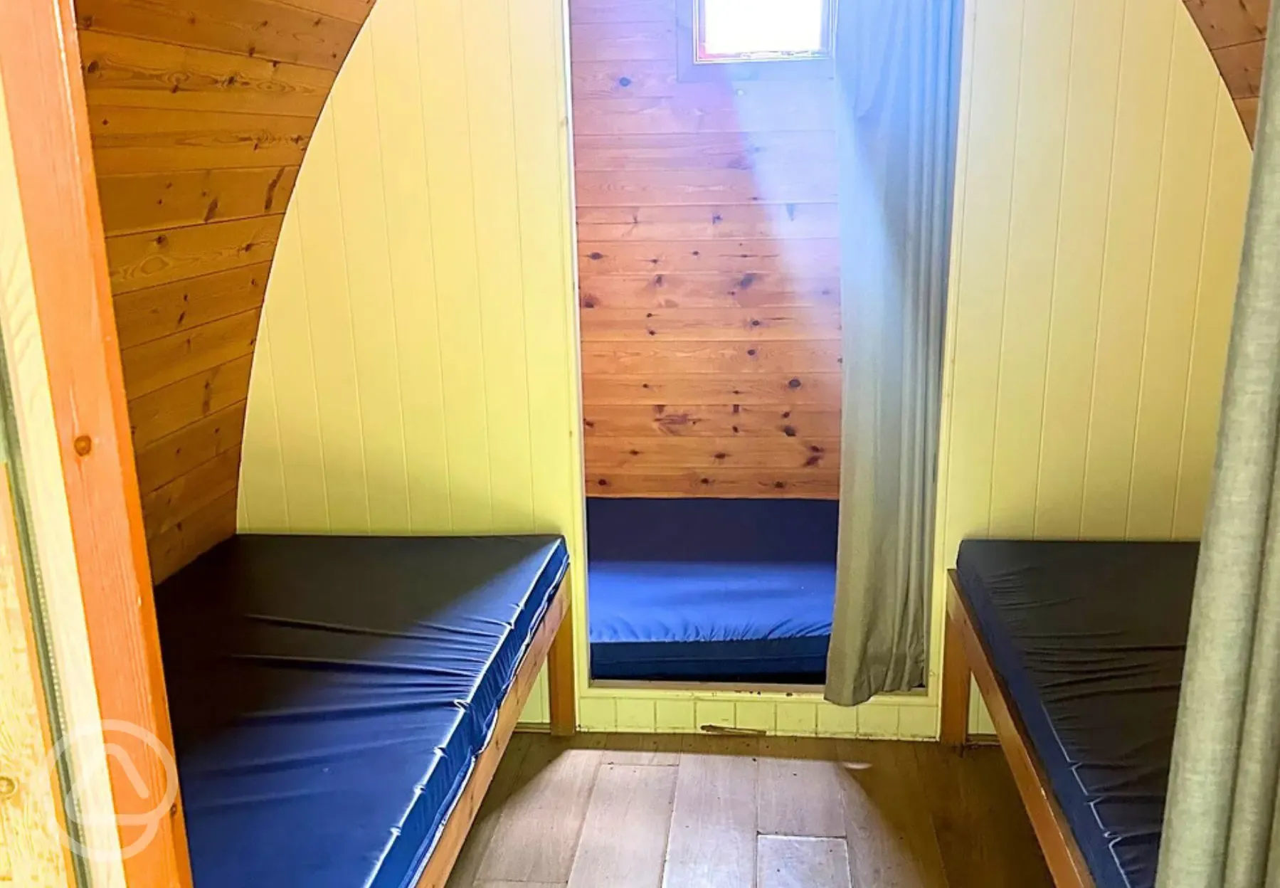 Camping pod interior with a double mattress and two single beds Camping pod interior with a double mattress and two single beds
