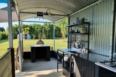 Shared outdoor kitchen with a pizza oven