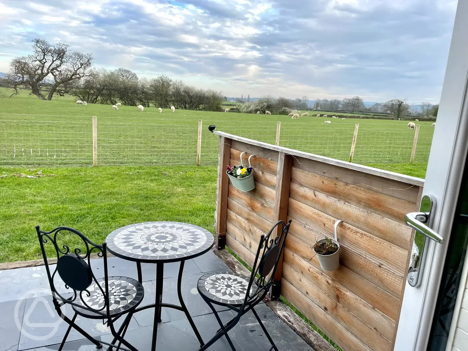 Luxury ensuite glamping pod decking with table and chairs