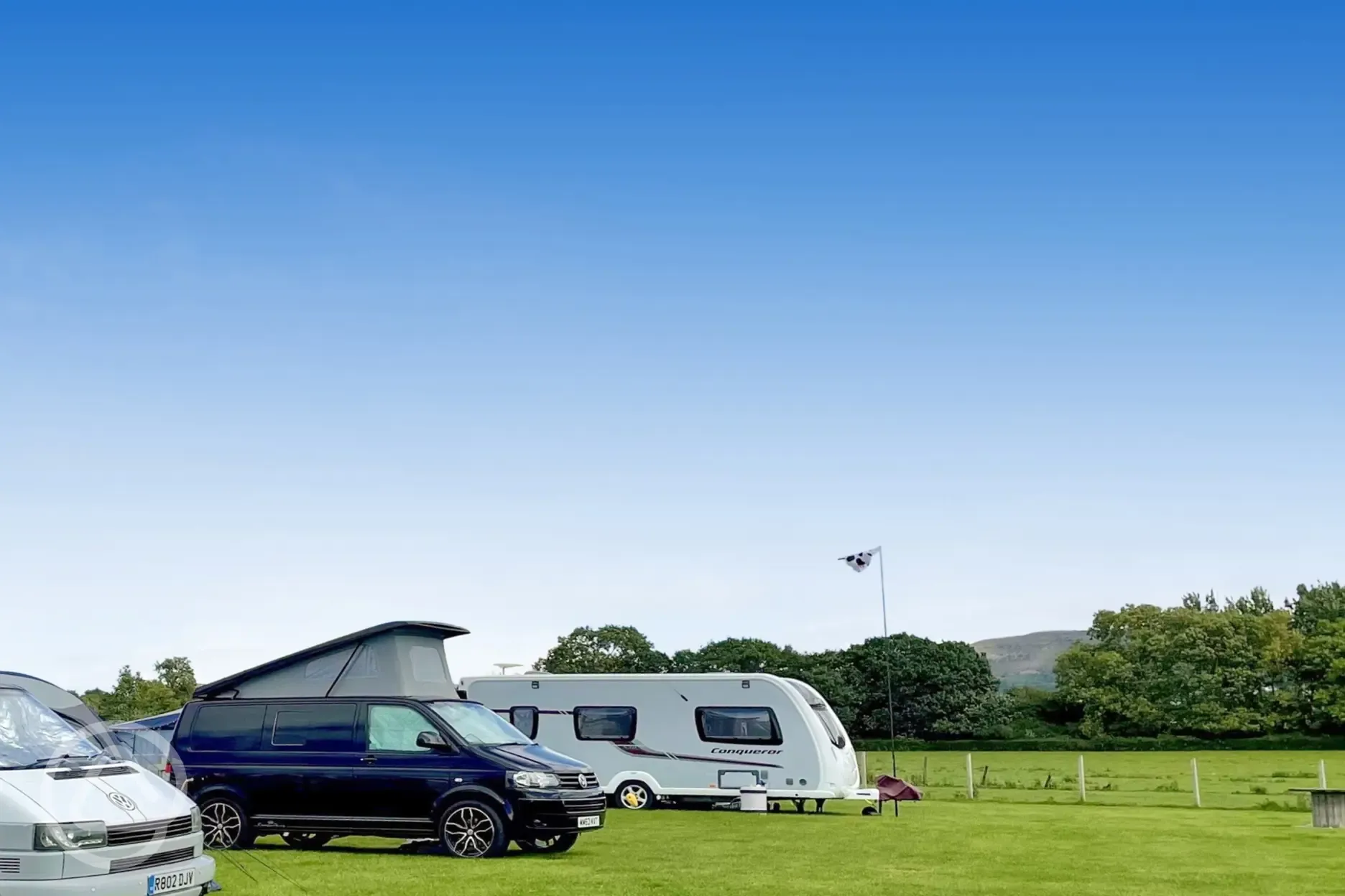 Electric grass touring pitches at Abbey Farm Caravan and Glamping