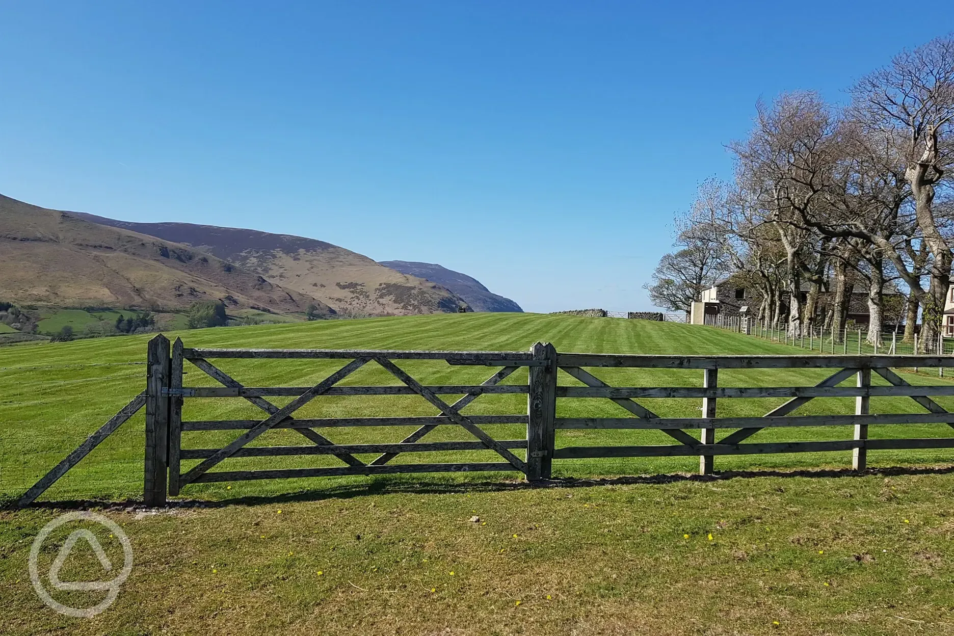 Site entrance and non electric grass campervan pitches