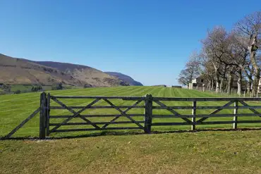 Site entrance and non electric grass campervan pitches