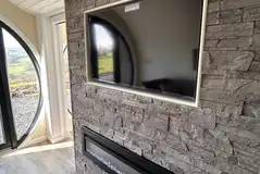Usk glamping pod living area TV and fireplace