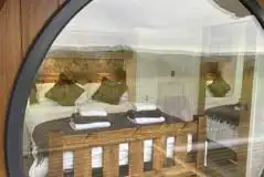 Eight person (Severn) pod king size bedroom with a large window