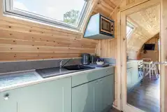 Kitchen with a microwave, oven, sink, kettle and toaster