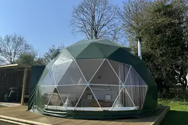 Glamping domes with decking areas and panel fronts