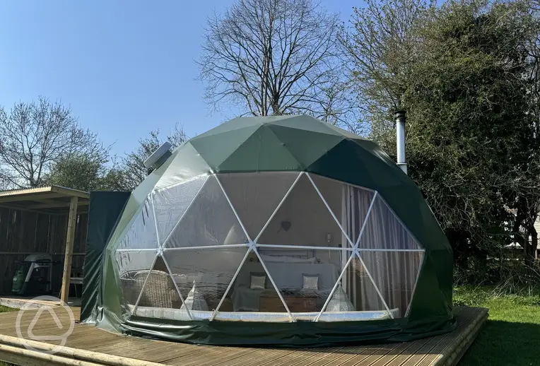 Glamping domes with decking areas and panel fronts