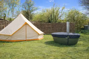 Grass pitch with a private wood-fired hot tub