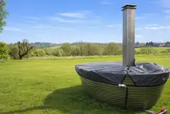Grass pitch with a private wood-fired hot tub