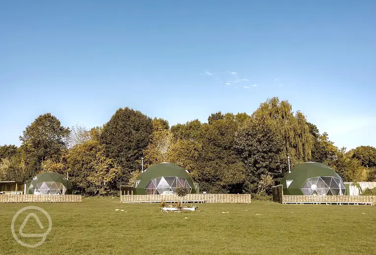 Glamping domes with private decking areas at Greenacres Campsite