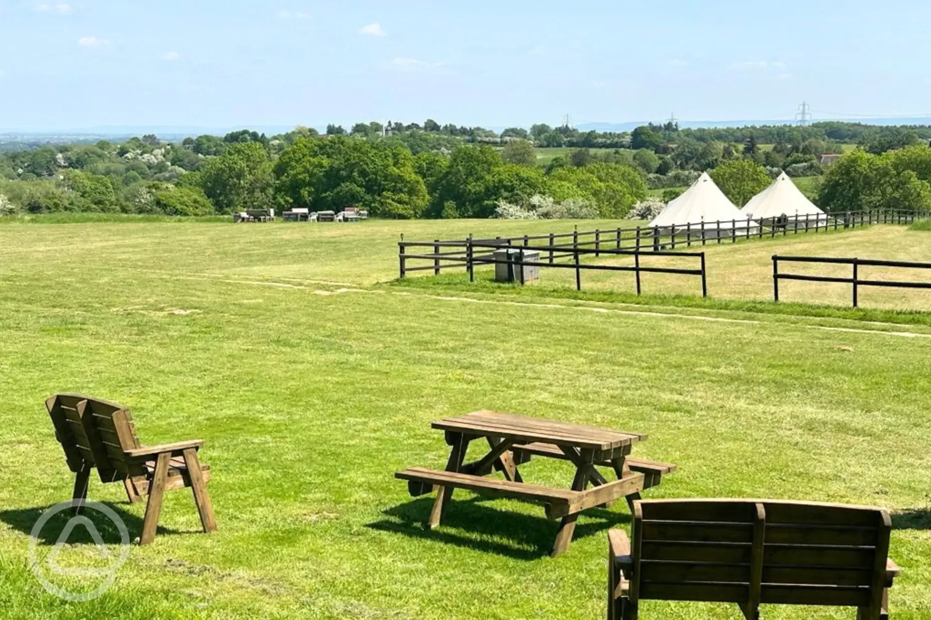 Bell tents surrounded by distant countryside views