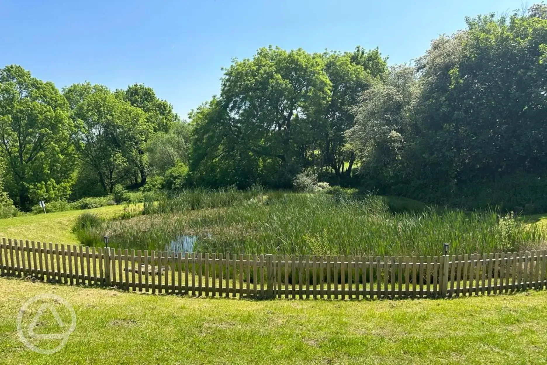 Fenced pond at Greenacres Campsite
