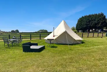 Close up of the bell tent with outdoor furniture