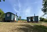 View of the two Valley ensuite shepherd's huts with outdoor seating