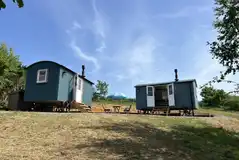 View of the two Valley ensuite shepherd's huts with outdoor seating View of the two Valley ensuite shepherd's huts with outdoor seating