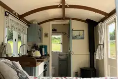 Inside main Valley hut with a king bed, kitchenette with hob, oven and fridge Inside main Valley hut with a king bed, kitchenette with hob, oven and fridge