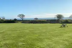 Non electric grass pitches with a picnic bench