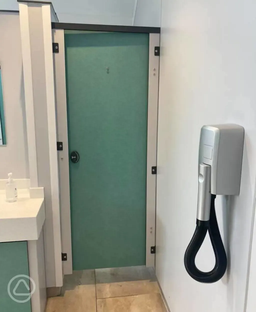 Private shower beside a hair dryer