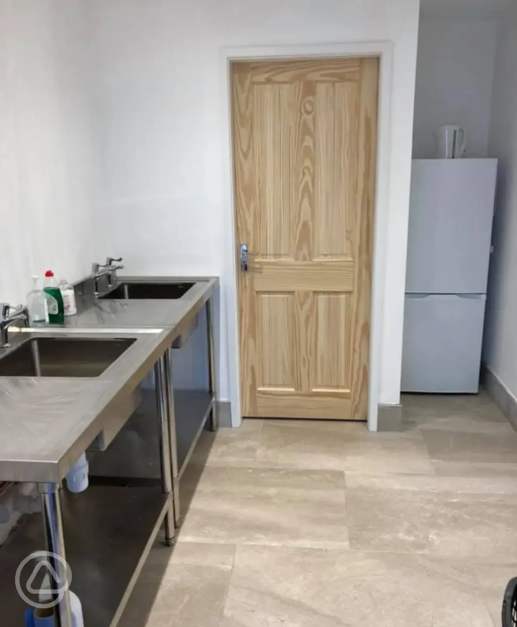 Indoor washing up area with a communal fridge and freezer