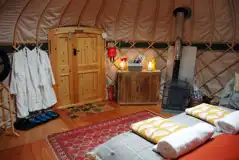 Orchard yurt interior with dressing gowns supplied