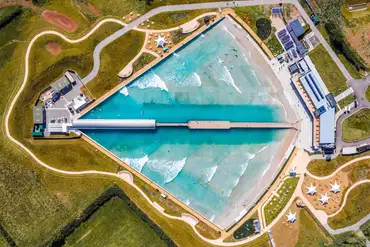Bird's eye view of Camp at The Wave with a central surfing wave pool