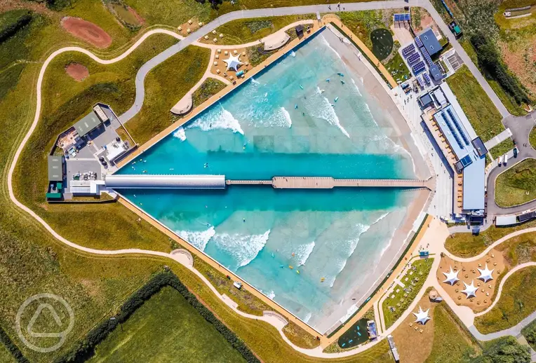 Bird's eye view of Camp at The Wave with a central surfing wave pool