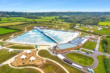 Aerial of The Wave with a wave pool and cafe/bar with outdoor seating
