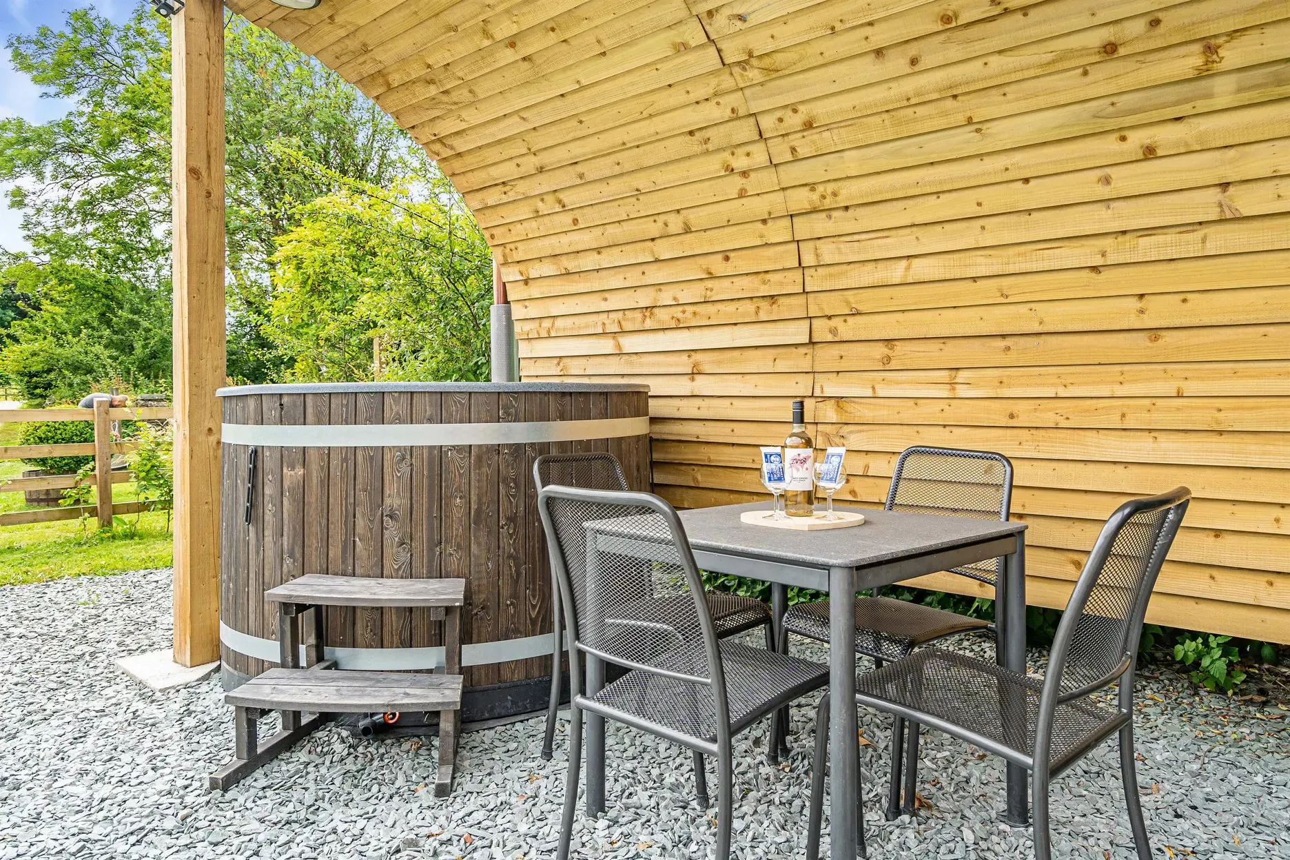 Wood fired hot tub and dining table of the ensuite glamping pod at Church House