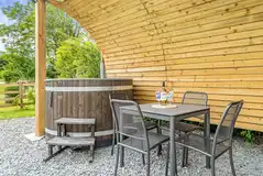Wood fired hot tub and dining table of the ensuite glamping pod at Church House Wood fired hot tub and dining table of the ensuite glamping pod at Church House