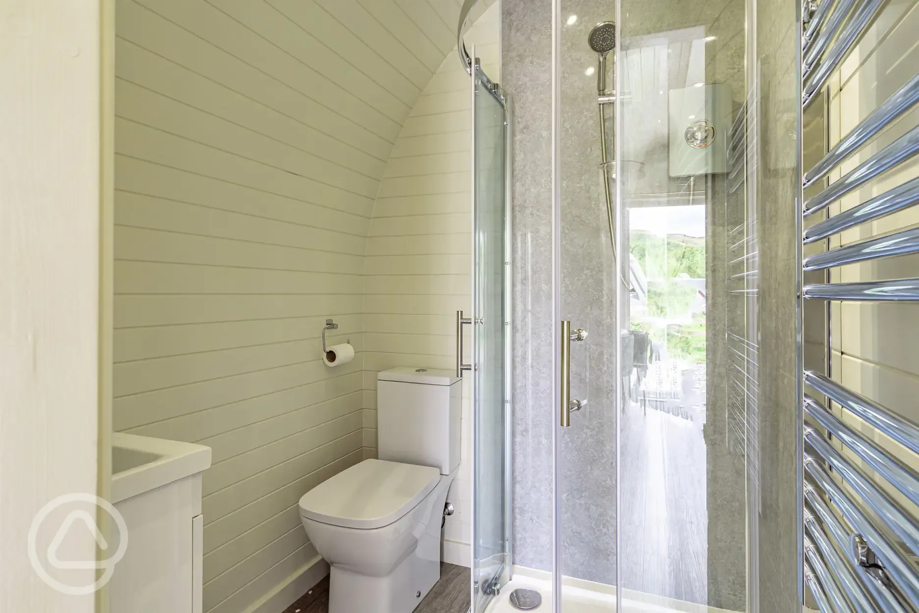 Glamping pod ensuite with toilet, shower, and towel rail 