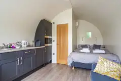 Kitchenette and double bed in the ensuite glamping pod at Church House Kitchenette and double bed in the ensuite glamping pod at Church House