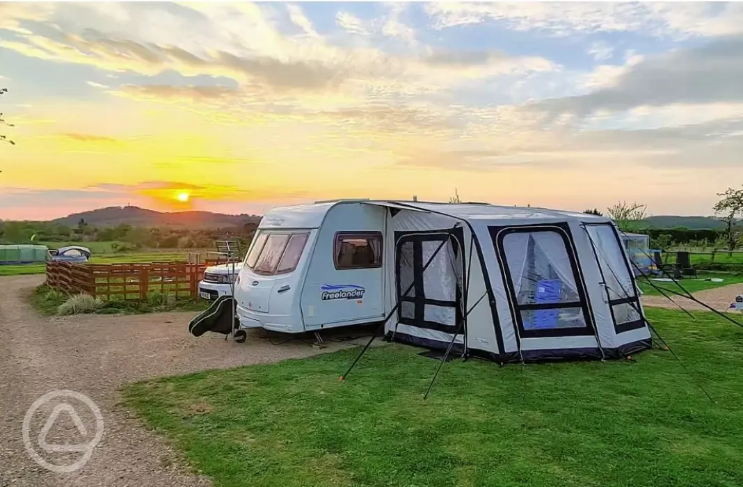 Electric hardstanding pitch with awning and countryside views